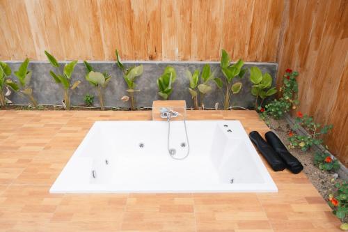 a white sink in a room with plants at Sapphire Private Glamping in Bandung