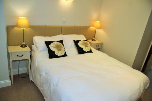 a bedroom with a white bed with two pillows at Bannerdale in Penrith