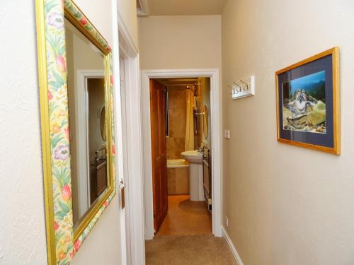 a hallway leading to a bathroom with a toilet at Grisdale View in Penrith