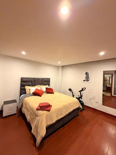 a bedroom with a bed and a bike in it at Apartamento T Premium in Ipiales