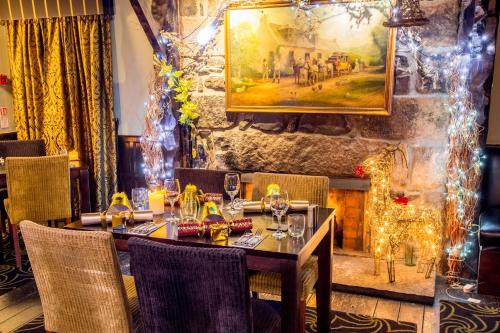 a table in a restaurant with christmas lights at The Cock and Bull in Balmedie
