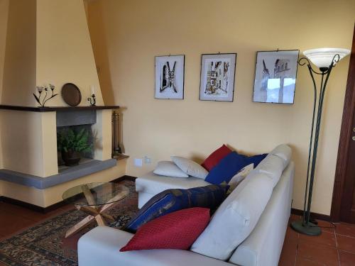 a living room with two white couches and a fireplace at Farmhouse in Monte Santa Maria Tiberina with garden in Monte Santa Maria Tiberina
