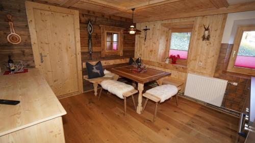 a dining room with a table and chairs in a cabin at Joggelerhof in Finkenberg
