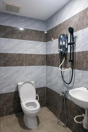 a bathroom with a shower and a toilet and a sink at ARK Port Dickson Seafront Hotel in Port Dickson