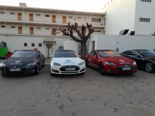 three cars parked in a parking lot in front of a building at Carlos III in Sant Carles de la Ràpita