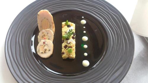 a plate with a piece of food on it at Hostellerie Saint Germain in Saint-Germain-lès-Arlay