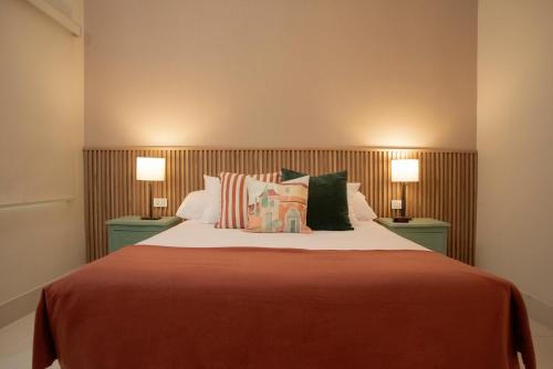 a bedroom with a large bed with two lamps at Lima Atelier Boutique in Lima
