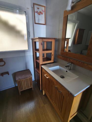 a bathroom with a sink and a mirror at Puig Rom Pau Vila in Roses