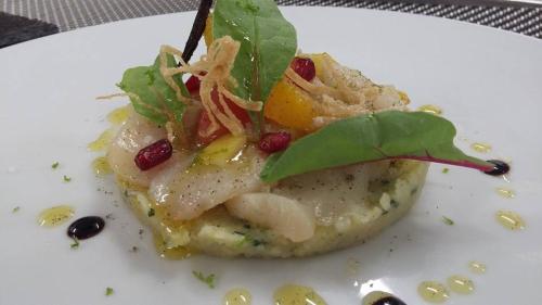a white plate with a piece of food on it at Hostellerie Saint Germain in Saint-Germain-lès-Arlay