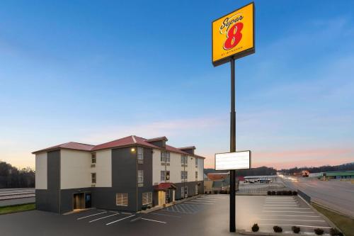 a sign in a parking lot in front of a hotel at Super 8 by Wyndham Chattanooga East - Hamilton Place in Chattanooga