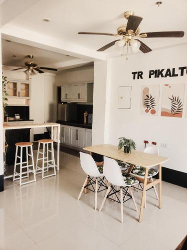 a kitchen and dining room with a table and chairs at El Kim Suites in Boac