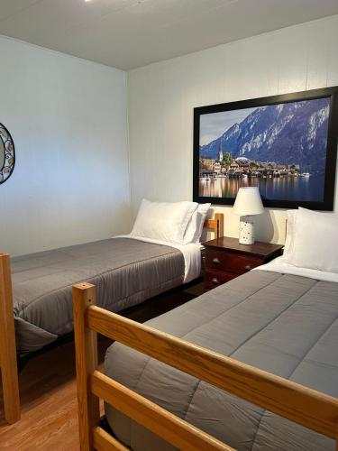 a bedroom with two beds and a large tv on the wall at 3333 Luz Del Valle Hotel Boutique in Valle de Guadalupe