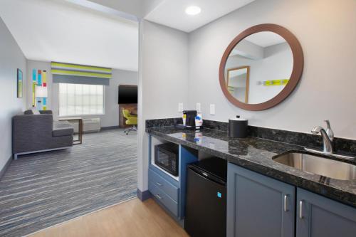a bathroom with a sink and a mirror at Hampton Inn and Suites St. Cloud in Saint Cloud