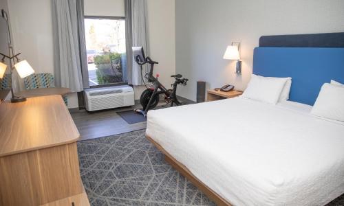 a hotel room with a large bed and a window at Hampton Inn Shrewsbury in Shrewsbury