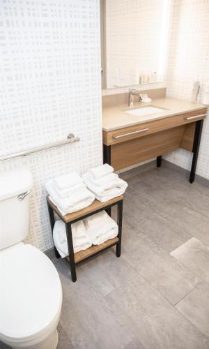a bathroom with a toilet and a sink at Hampton Inn Shrewsbury in Shrewsbury