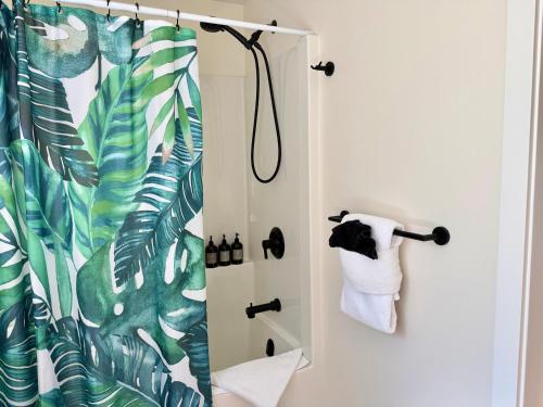 a bathroom with a shower curtain and a toilet at Tofino Trailhead in Tofino