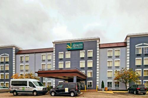 a hotel with cars parked in front of it at Quality Inn & Suites CVG Airport in Erlanger