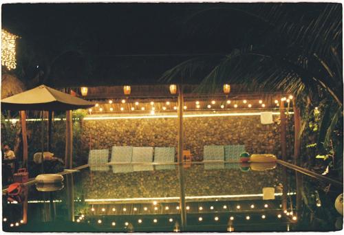 a patio with a table and chairs and lights at Banyan Villa Nha Trang in Nha Trang