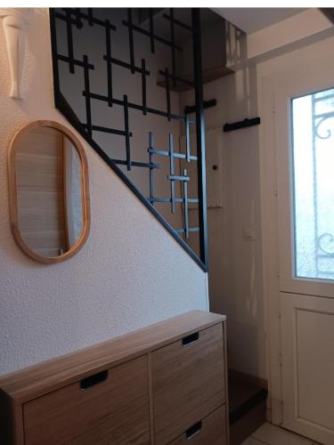 a bathroom with a mirror and a wooden dresser at Casa Littoral in Le Grau-dʼAgde