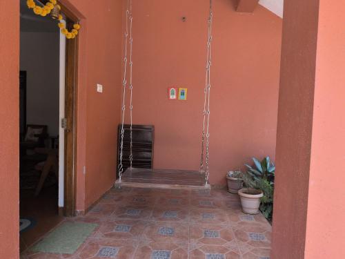 a hallway with a swing hanging from a wall at Nivritti Villa 2BHK Private Villa in Matheran Full Privacy & Prime Location in Matheran in Matheran