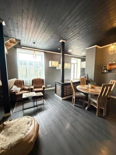 a living room with a couch and a dining room table at MaxiMar Apartment With Sauna in Valga