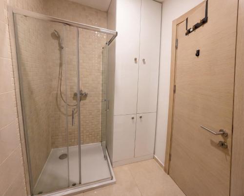 a shower with a glass door in a bathroom at Status S in Bečići