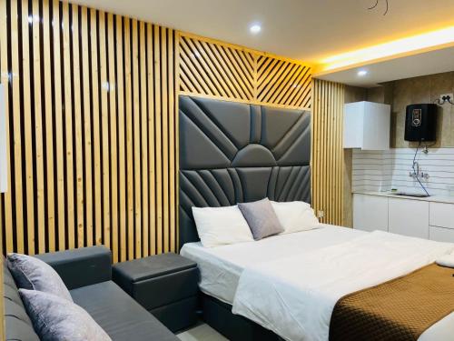 a bedroom with a bed and a chair in it at The Warmwood Studio in Dehradun