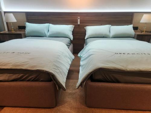 two beds sitting next to each other in a bedroom at Yana Apec Phu Yen in Tuy Hoa