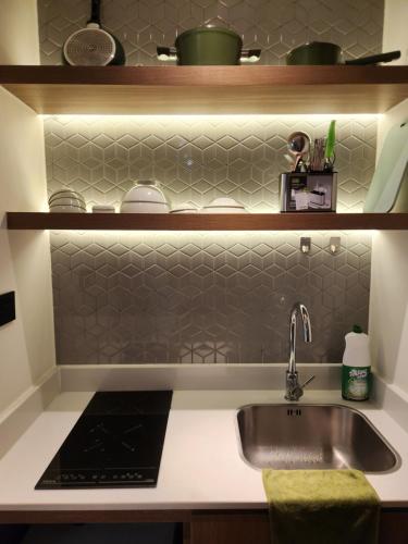 a kitchen with a sink and a counter at Yana Apec Phu Yen in Tuy Hoa