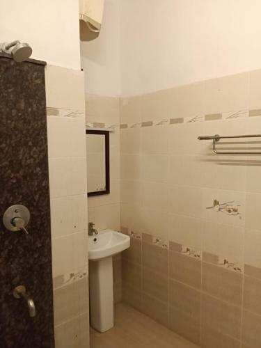 a bathroom with a sink and a toilet and a mirror at The Temple Tree Residence in Yelagiri