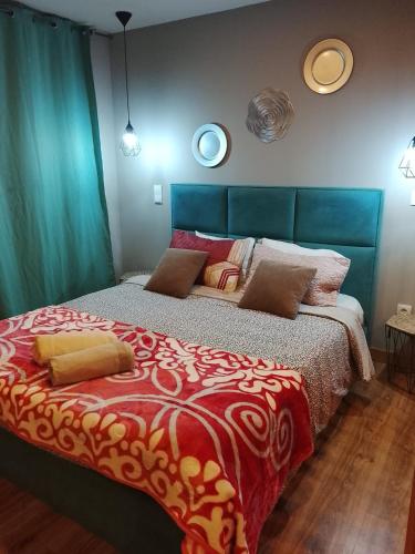 a bedroom with a bed with a red and white comforter at Porto Centro Station in Porto