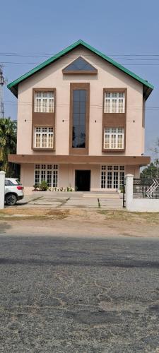 a large building with a lot of windows at The Rustic Inn Kaziranga in Kāziranga