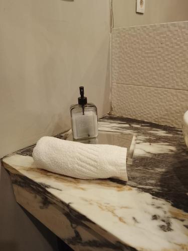 a towel on a counter with a bottle of soap at Porto Centro Station in Porto