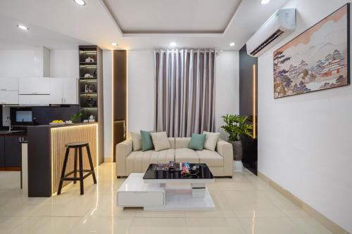 a living room with a couch and a table at Hanami Residence - Self Check-in Accommodation in Danang