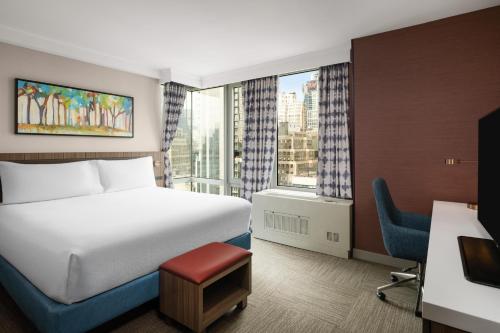 a hotel room with a bed and a window at Hilton Garden Inn West 35th Street in New York