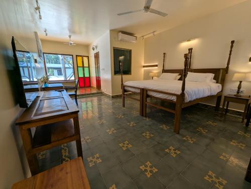 a bedroom with a bed and a table in it at Clouthy Villa in Cochin