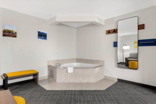 a waiting room with a sink and a mirror at Comfort Inn & Suites Suwanee - Sugarloaf in Suwanee