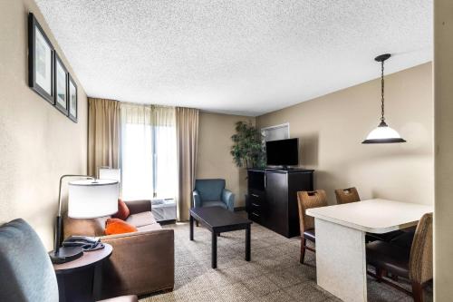 a hotel room with a living room at Comfort Inn Evansville East in Evansville