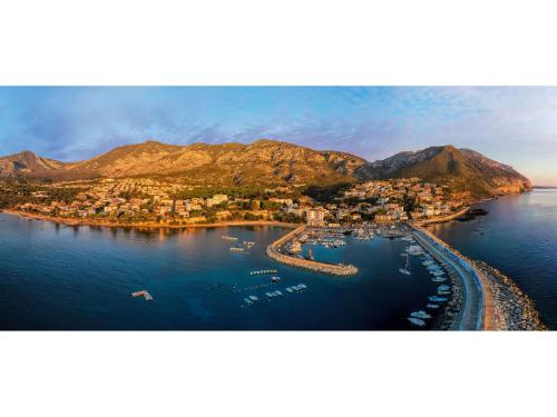 an aerial view of a harbor with boats in the water at I Ginepri Hotel in Cala Gonone