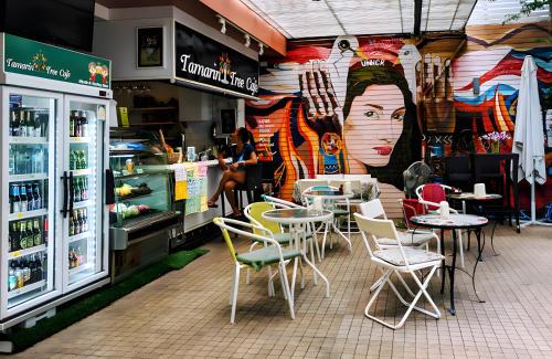 a restaurant with tables and chairs and a mural of a woman at AT Pranakorn Khaosan - Samsen Soi 2 in Bang Bua Thong Railway Station