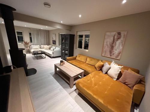a living room with a couch and a table at Big villa with outbuilding in Sarpsborg