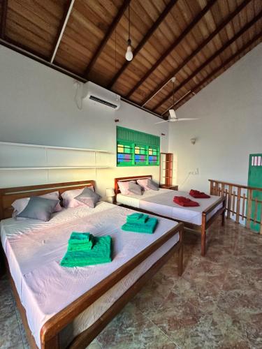 a bedroom with two beds in a room at Rella Dream in Matara
