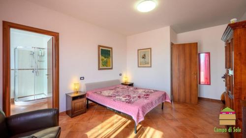 a bedroom with a bed and a glass shower at In Vino Veritas B&B in Arcola
