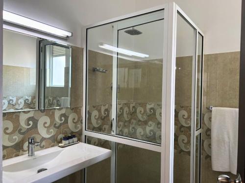 a bathroom with a sink and a shower at The Suite 262 in Negombo