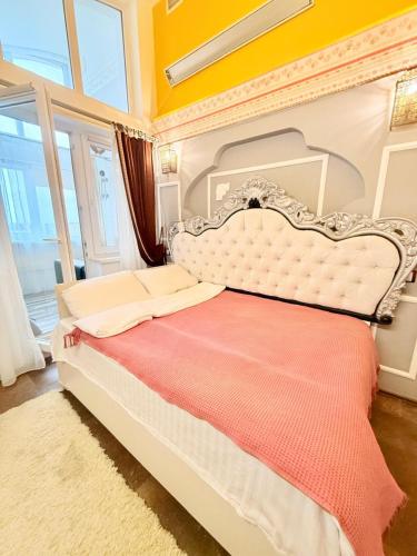 a bedroom with a white bed with a red blanket at 1 Double Budget Room Center Park in Chişinău