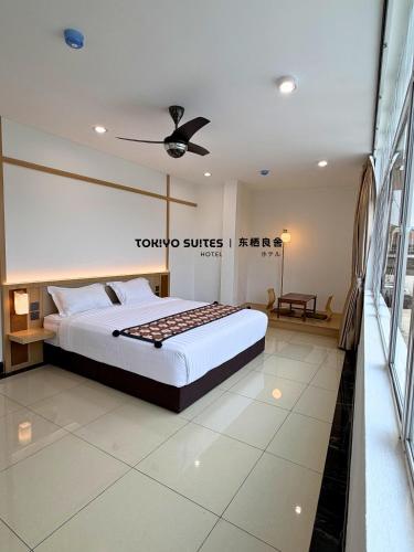 a bedroom with a king sized bed in a room at Tokiyo Suites Hotel Kinta River Ipoh Town in Ipoh