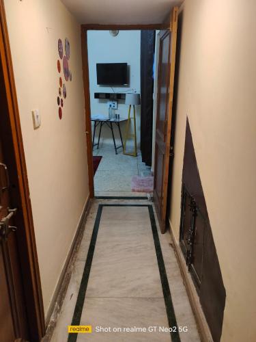 a hallway leading into a living room with a fireplace at Uma's Homestay in Gwalior