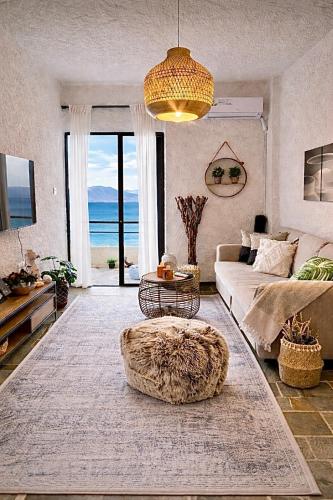 a living room with a couch and a table at SeaTerra Boutique suite in Kalamos