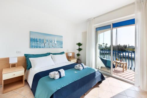 a bedroom with a large bed and a balcony at Casa Celeste Sea View - Riviera Collection in Misano Adriatico