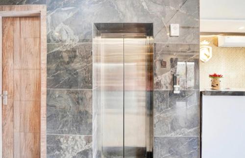 a shower with a glass door in a bathroom at GREAT ROYAL eMPIRE in Tājganj